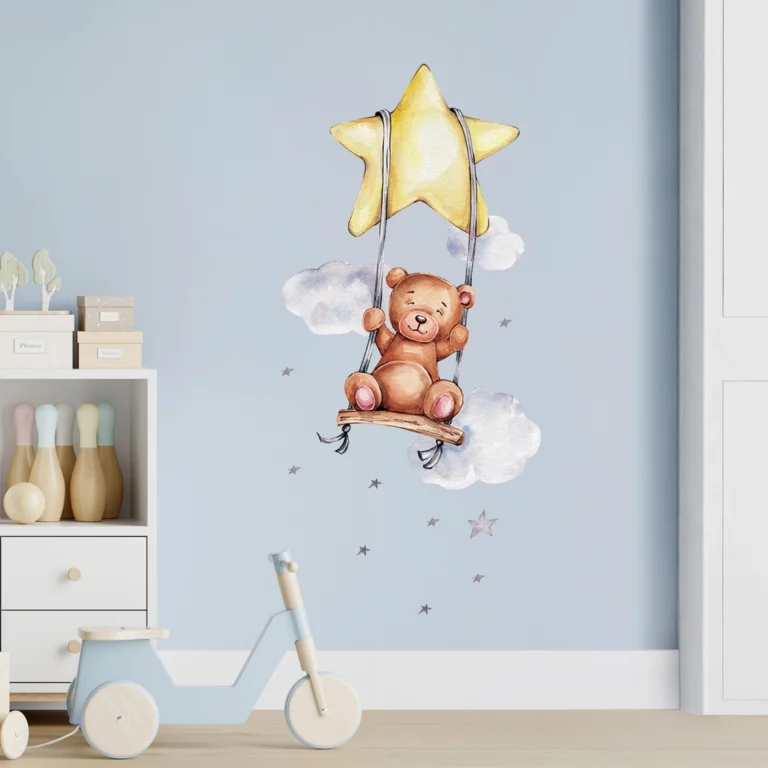 SIPO wall stickers – teddy bear on a swing next to a yellow star: watercolour teddy bear, clouds and small stars on a blue wall in a baby's room.